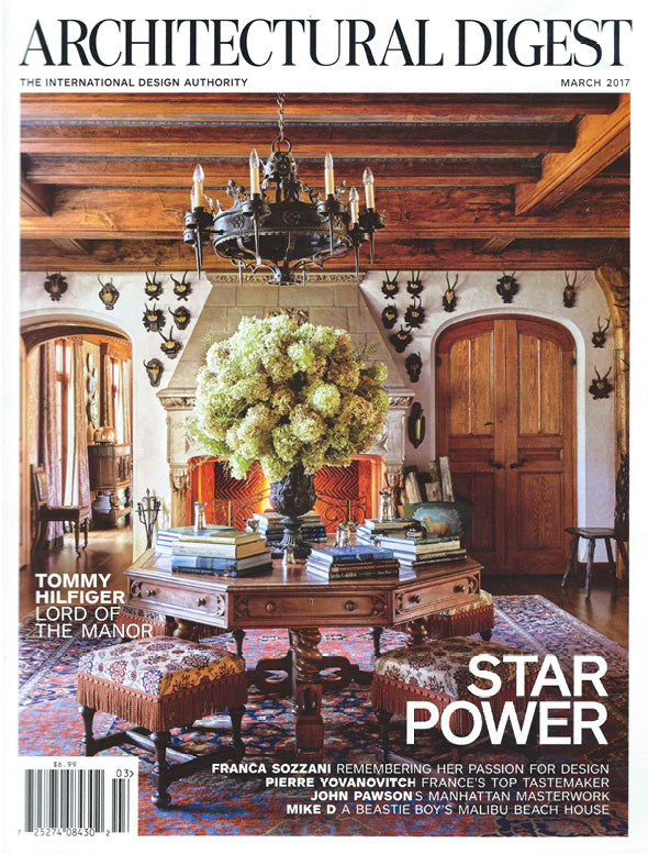 Cover of Architectural Digest magazine featuring a luxurious interior design with a chandelier and table.