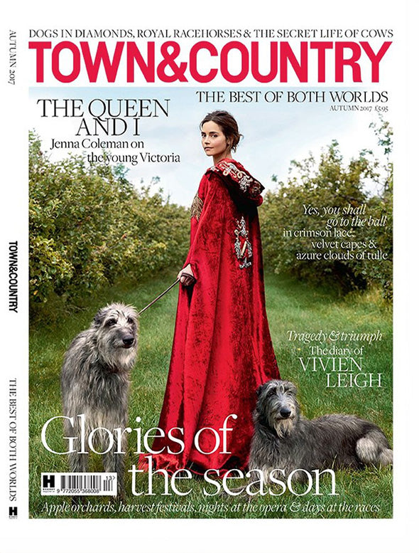 Town & Country magazine cover featuring a woman in a red dress with two dogs, set against a scenic background.